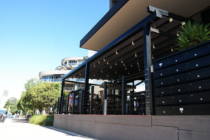 Outside exterior view of restaurant and table & chairs outdoor dining area